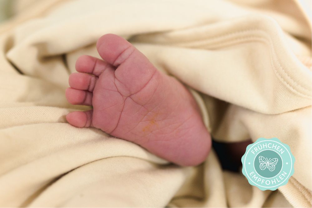 Frühchen liegt geborgen in weicher Bio-Kleidung aus Pima Baumwolle – empfohlen für sensible Haut
